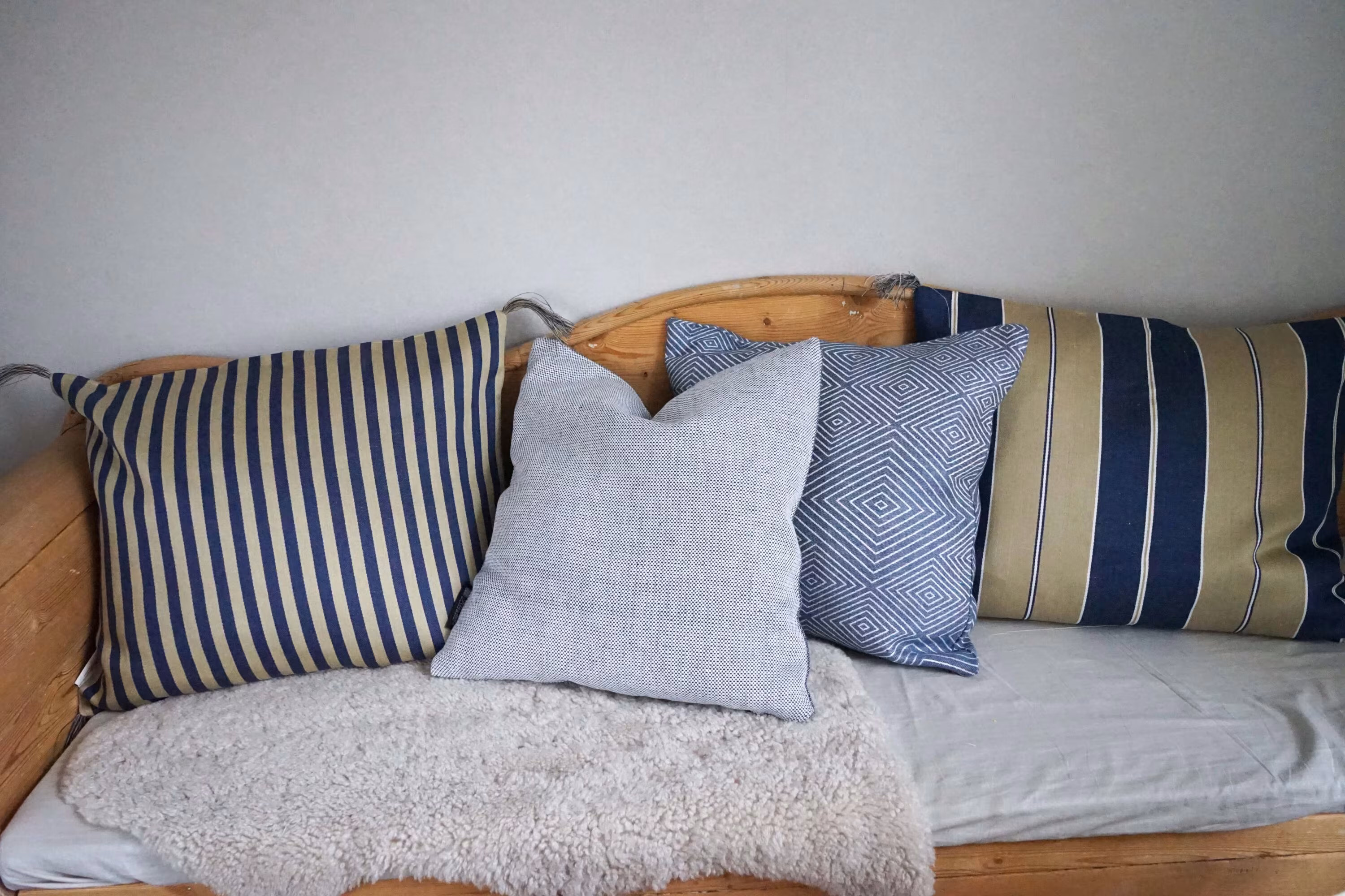 Linen cushions from Klässbols Linneväveri in blue tones in a kitchen sofa.