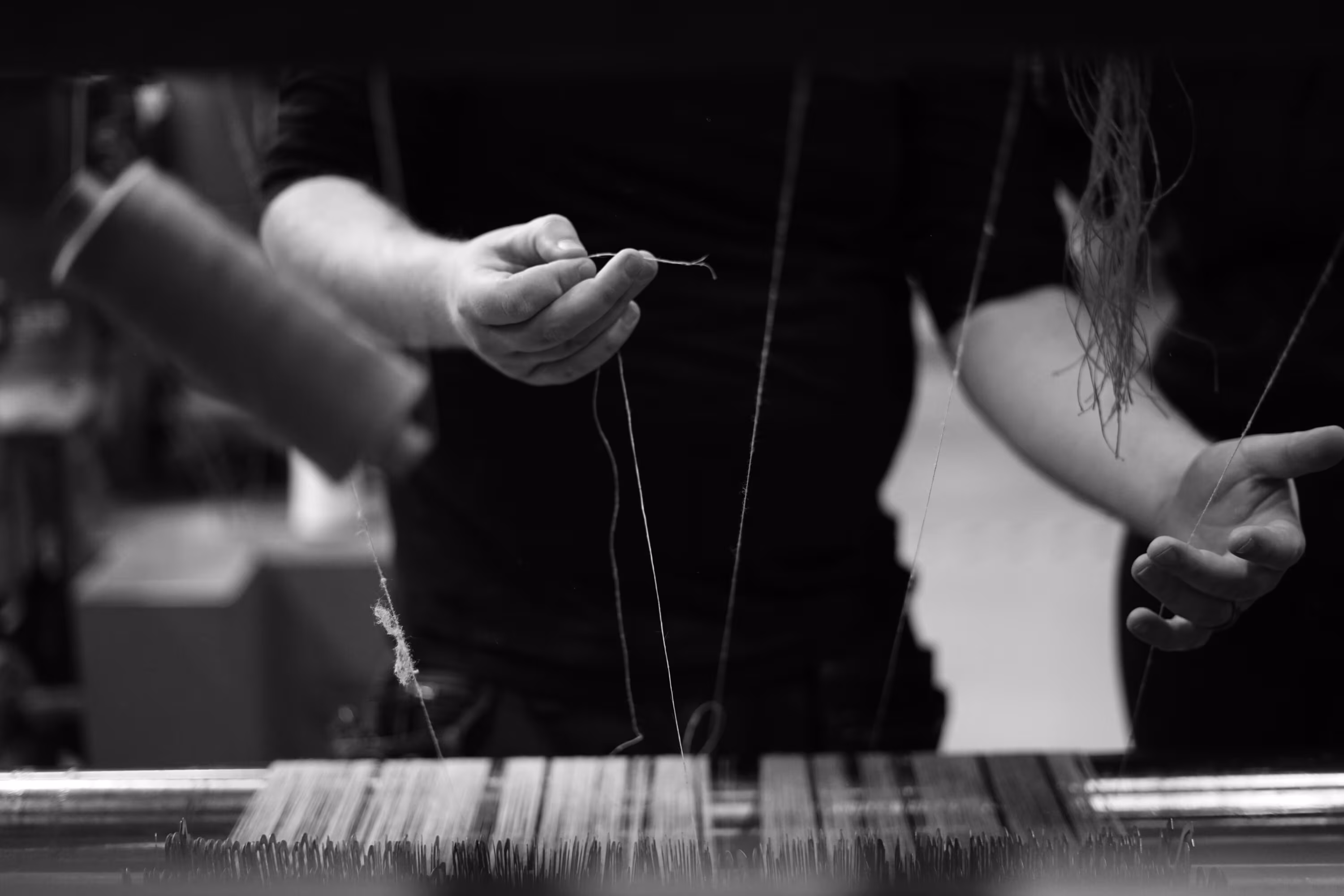 Black and white image and close-up of hands in a weaving machine